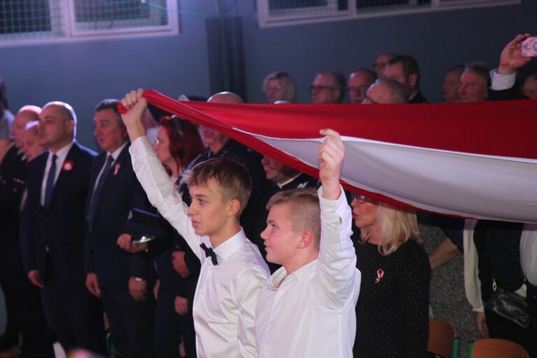 Uczestnicy widowiska wraz z uczniami śpiewają hymn Polski